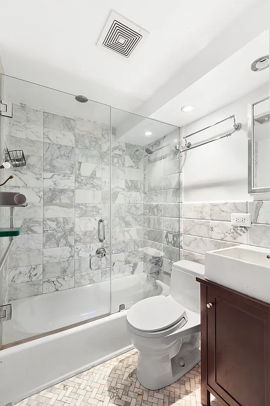 184 Thompson Street, Unit 6D Manhattan, NY 10012 - Photo 6 of 7 a bathroom with a sink a toilet and shower