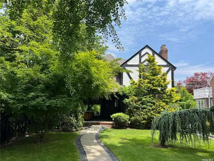 a view of a house with a yard and a garden