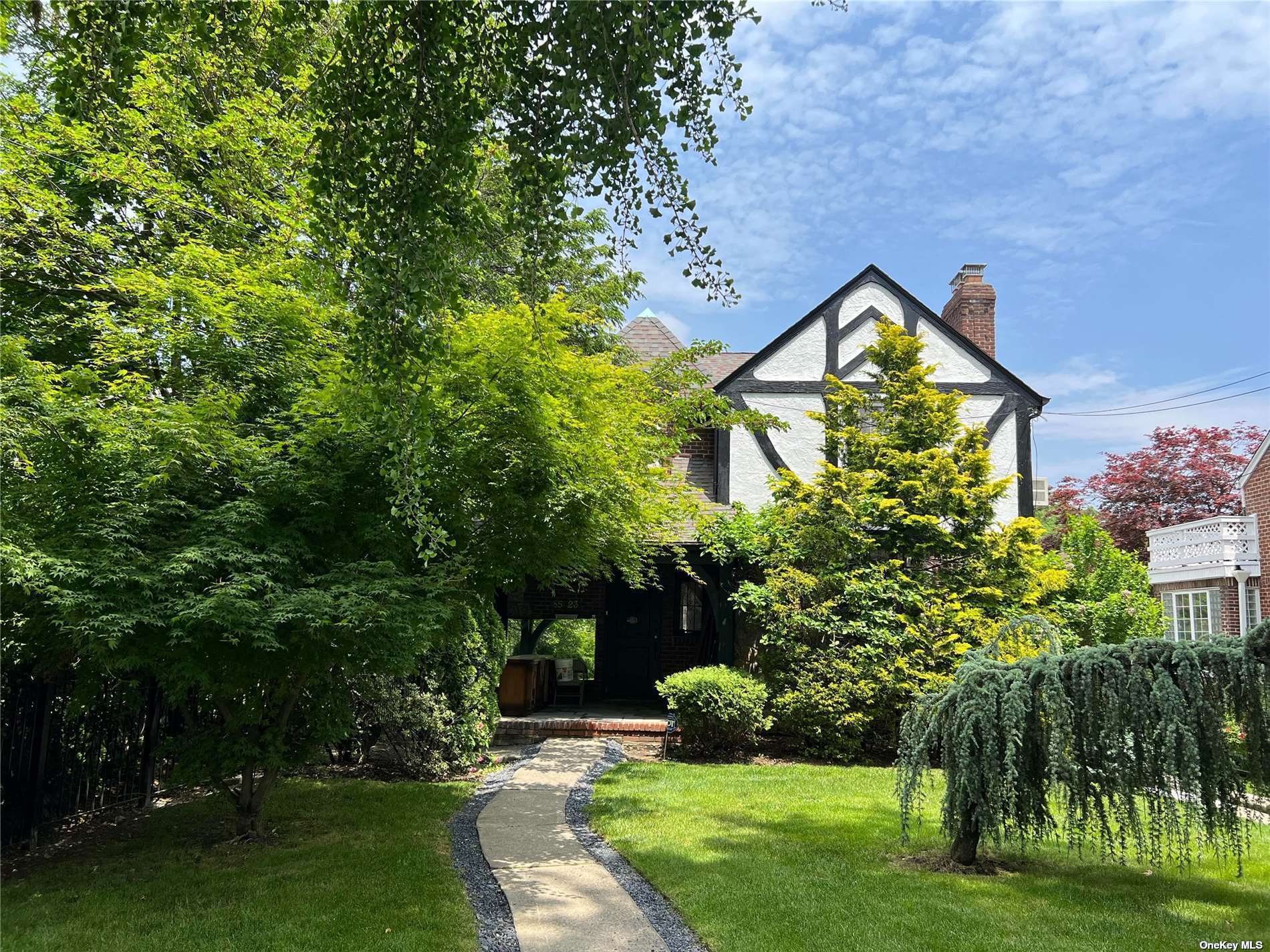 85-23 Edgerton Boulevard Queens, NY 11432 - Photo 2 of 36 a view of a house with a yard and a garden