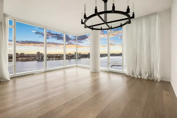 a view of room with window and wooden floor