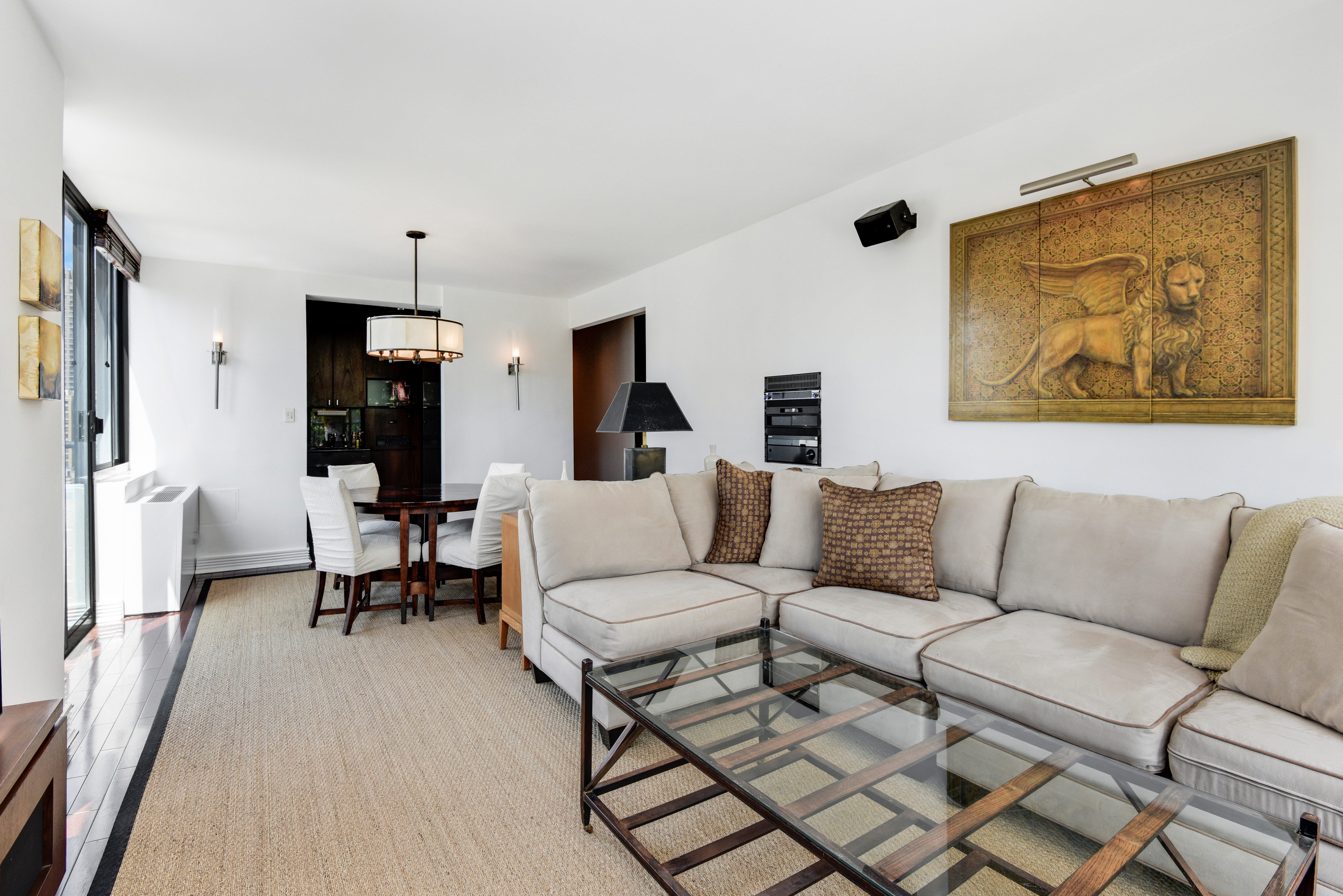 343 East 74th Street, Unit 15D Manhattan, NY 10021 - Photo 5 of 14 a living room with furniture and a wooden floor