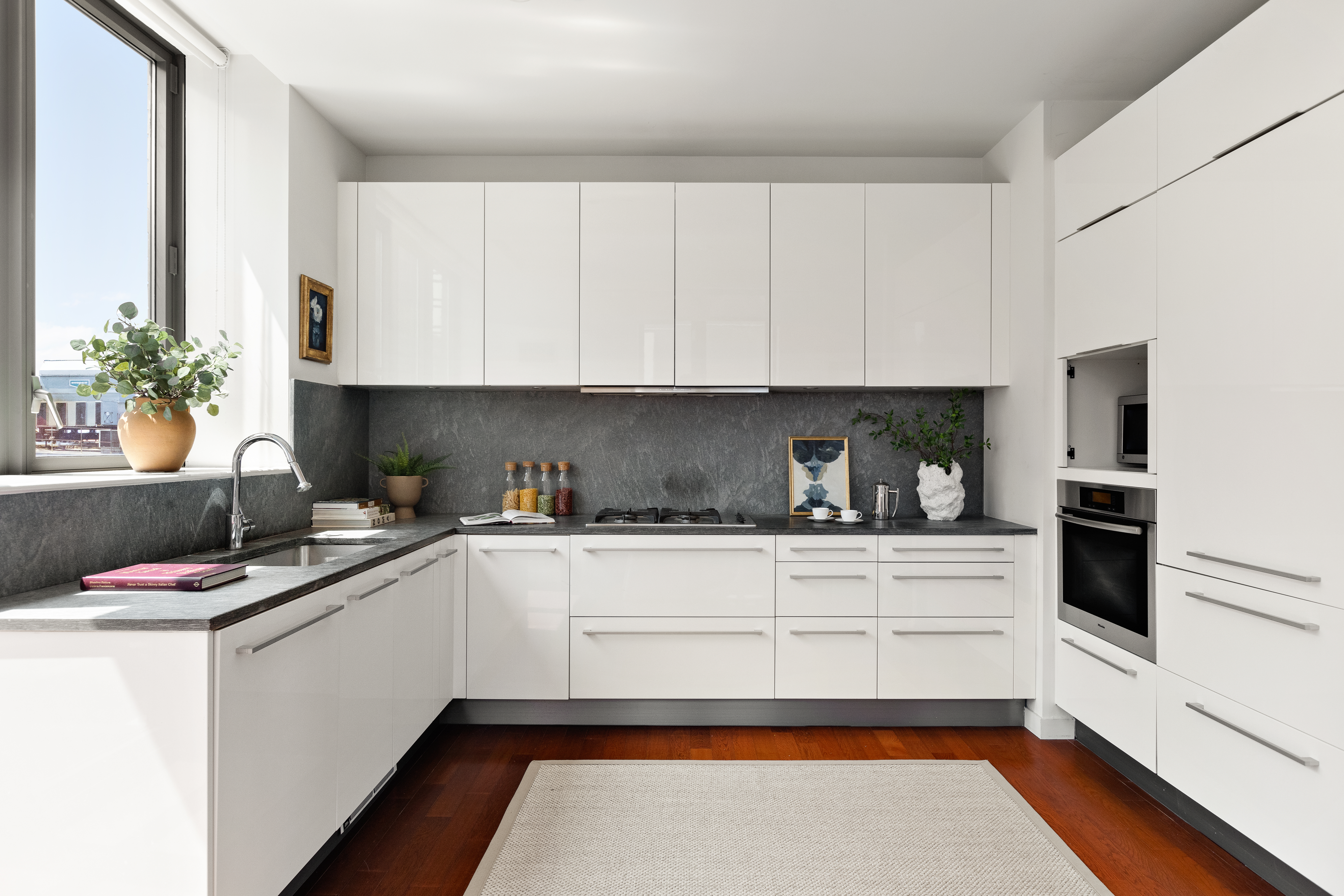 4 West 21st Street, Unit 16A Manhattan, NY 10010 - Photo 4 of 15 a kitchen with granite countertop a sink stainless steel appliances and cabinets