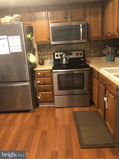 a kitchen with a sink and a refrigerator