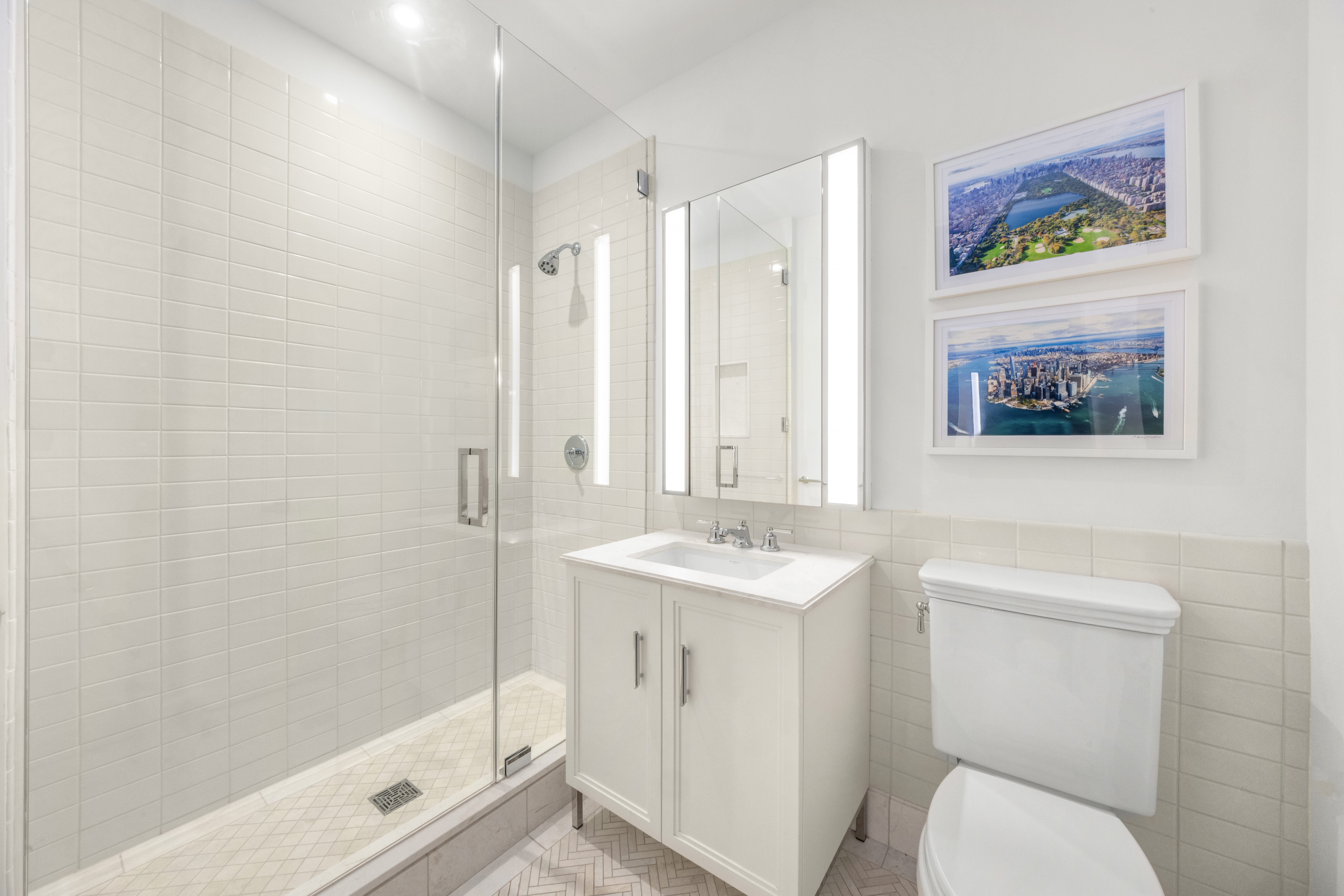 100 Barclay Street, Unit 16H Manhattan, NY 10007 - Photo 10 of 12 a bathroom with a toilet a sink and mirror