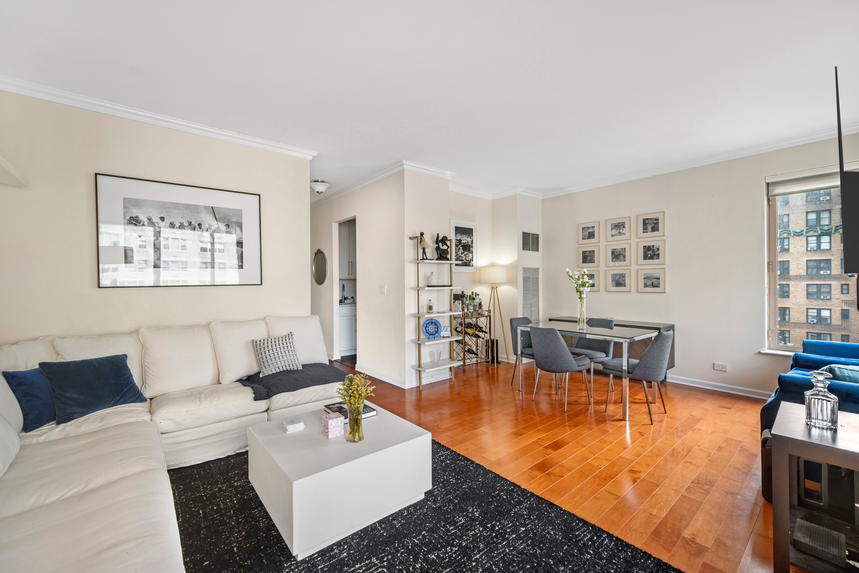 200 East 69th Street, Unit 12E Manhattan, NY 10021 - Photo 3 of 6 a living room with furniture and a table