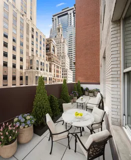 a view of a patio with a table and chairs and potted plants