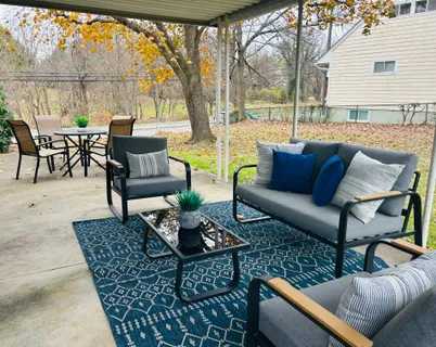a outdoor space with patio the couches and a dining table with garden view