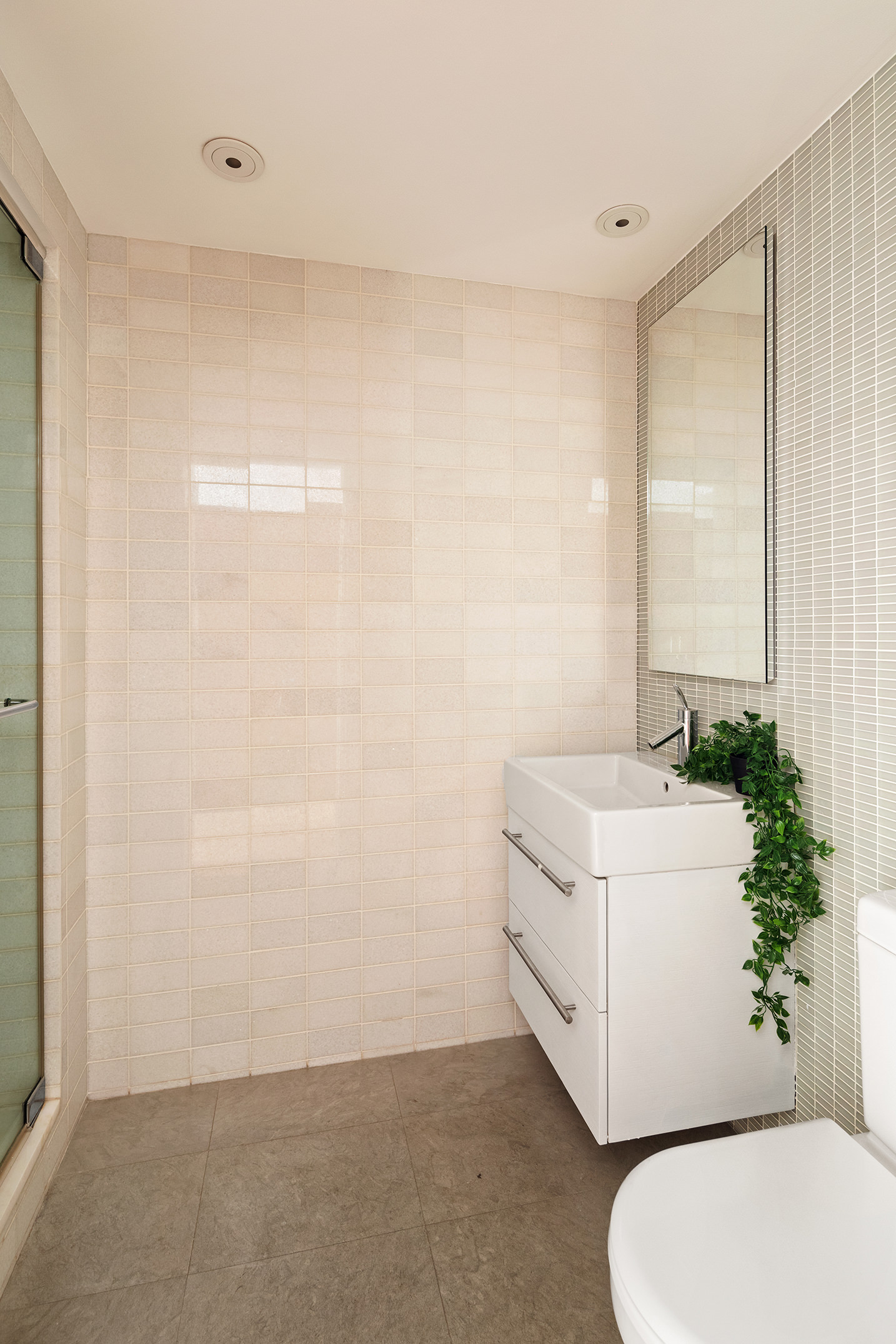 16 Warren Street, Unit 5 Manhattan, NY 10007 - Photo 13 of 18 a bathroom with a sink a toilet and a mirror