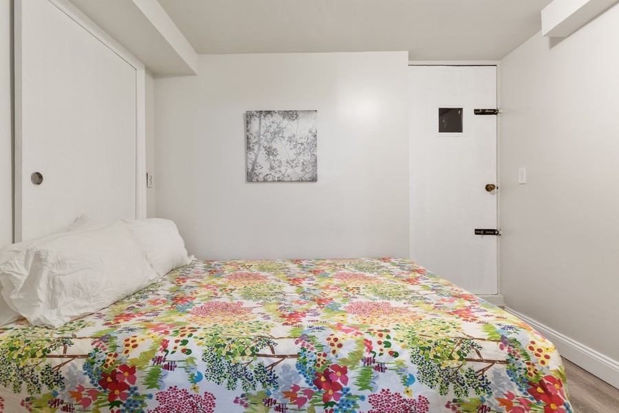673 Metropolitan Avenue, Unit B Brooklyn, NY 11211 - Photo 4 of 7 a bedroom with a bed and a painting on the wall