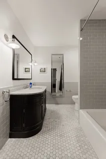 a spacious bathroom with a bathtub and a sink