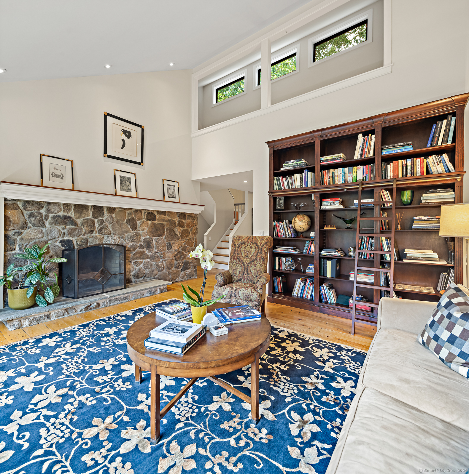 13 Bittersweet Road Weston, CT 06883 - Photo 2 of 35 a living room with furniture a rug and a fireplace