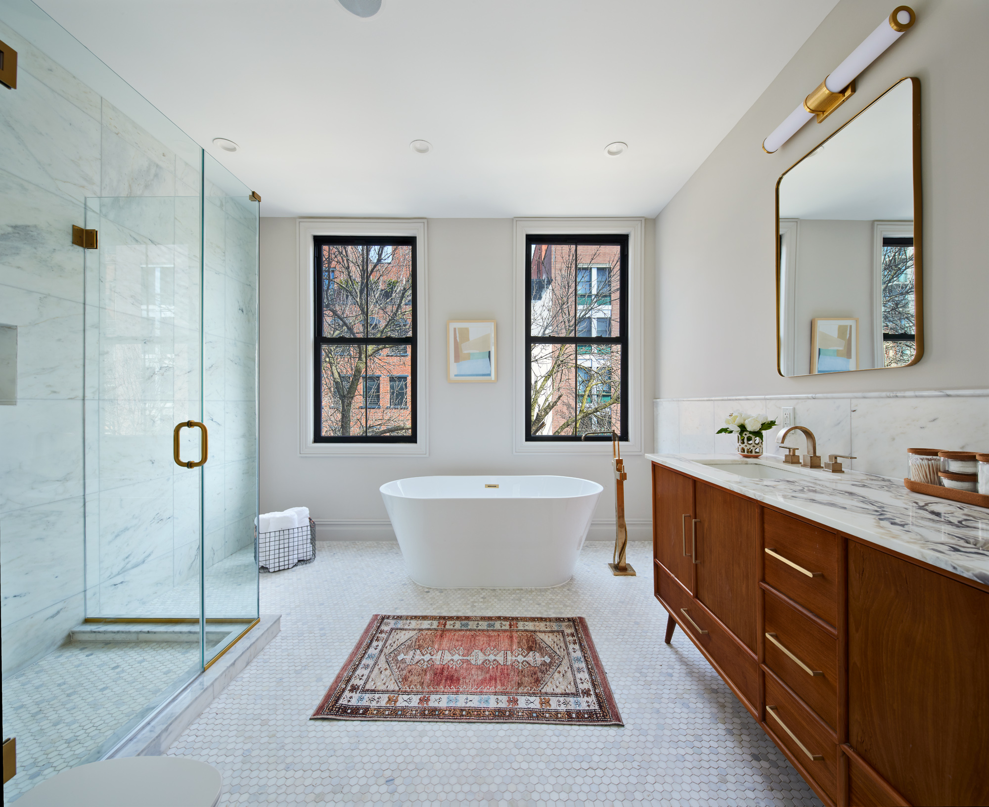 576 Carroll Street, Unit 2 Brooklyn, NY 11215 - Photo 8 of 15 a spacious bathroom with a double vanity sink a mirror and a bathtub