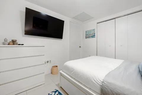a bedroom with a bed and a flat screen tv