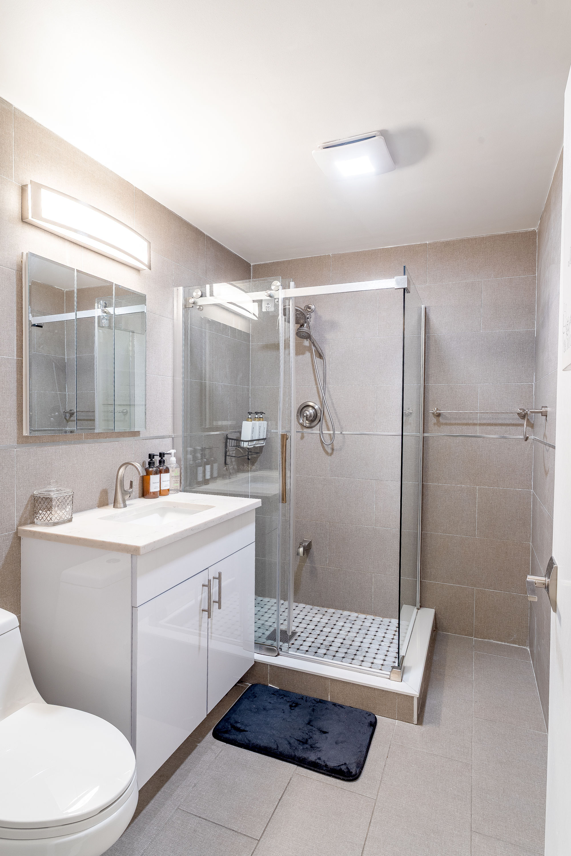 212 East 70th Street, Unit B Manhattan, NY 10021 - Photo 14 of 17 a bathroom with a sink a toilet and shower
