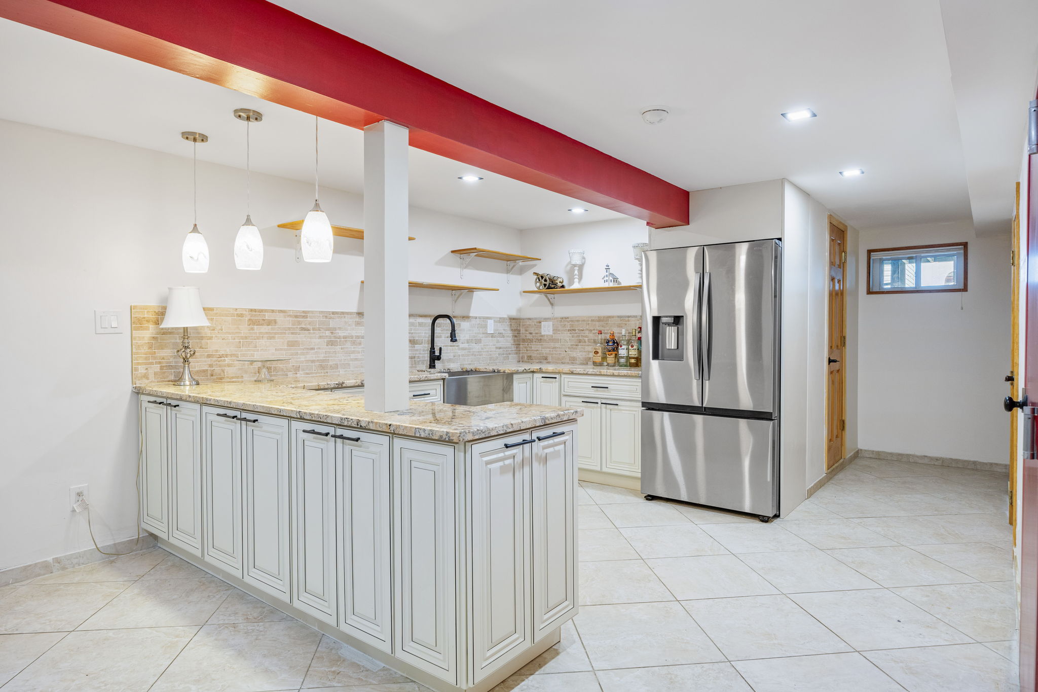 25-69 46th Street Queens, NY 11103 - Photo 27 of 33 a kitchen with white cabinets and refrigerator