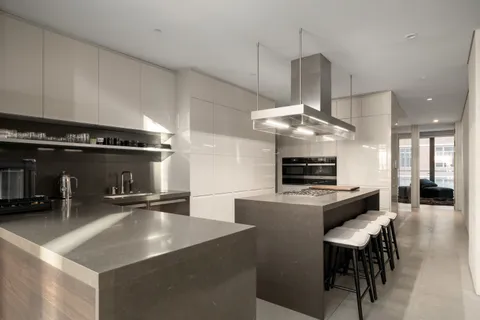 a kitchen with stainless steel appliances granite countertop a sink a stove and a refrigerator