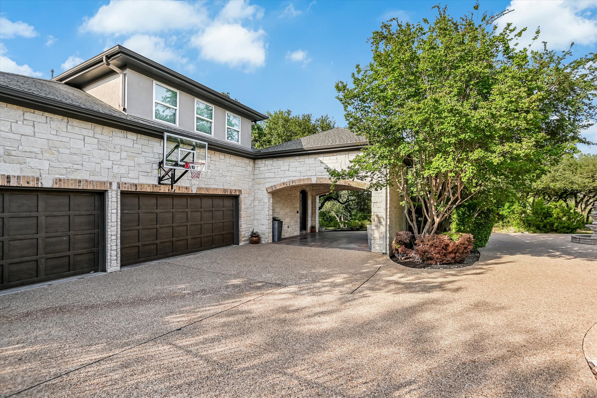 1422 Palomino Ridge Drive Austin, TX 78733 - Photo 57 of 60 a front view of a house with a yard and garage