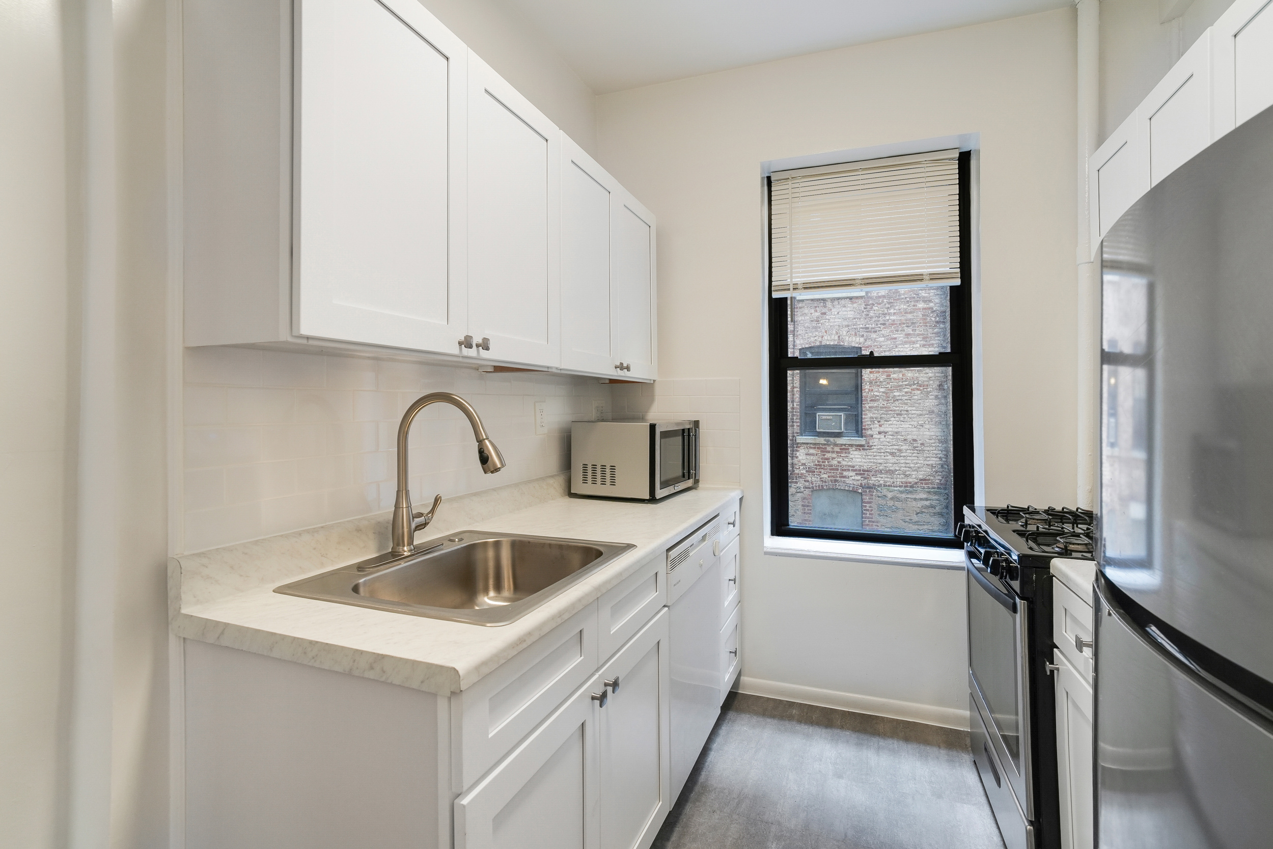 507 West 111th Street, Unit 3 Manhattan, NY 10025 - Photo 5 of 11 a kitchen with a sink and cabinets
