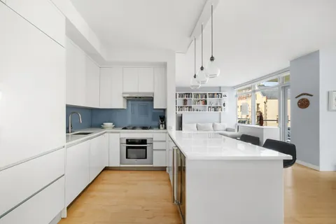 a kitchen with granite countertop a sink stove and refrigerator