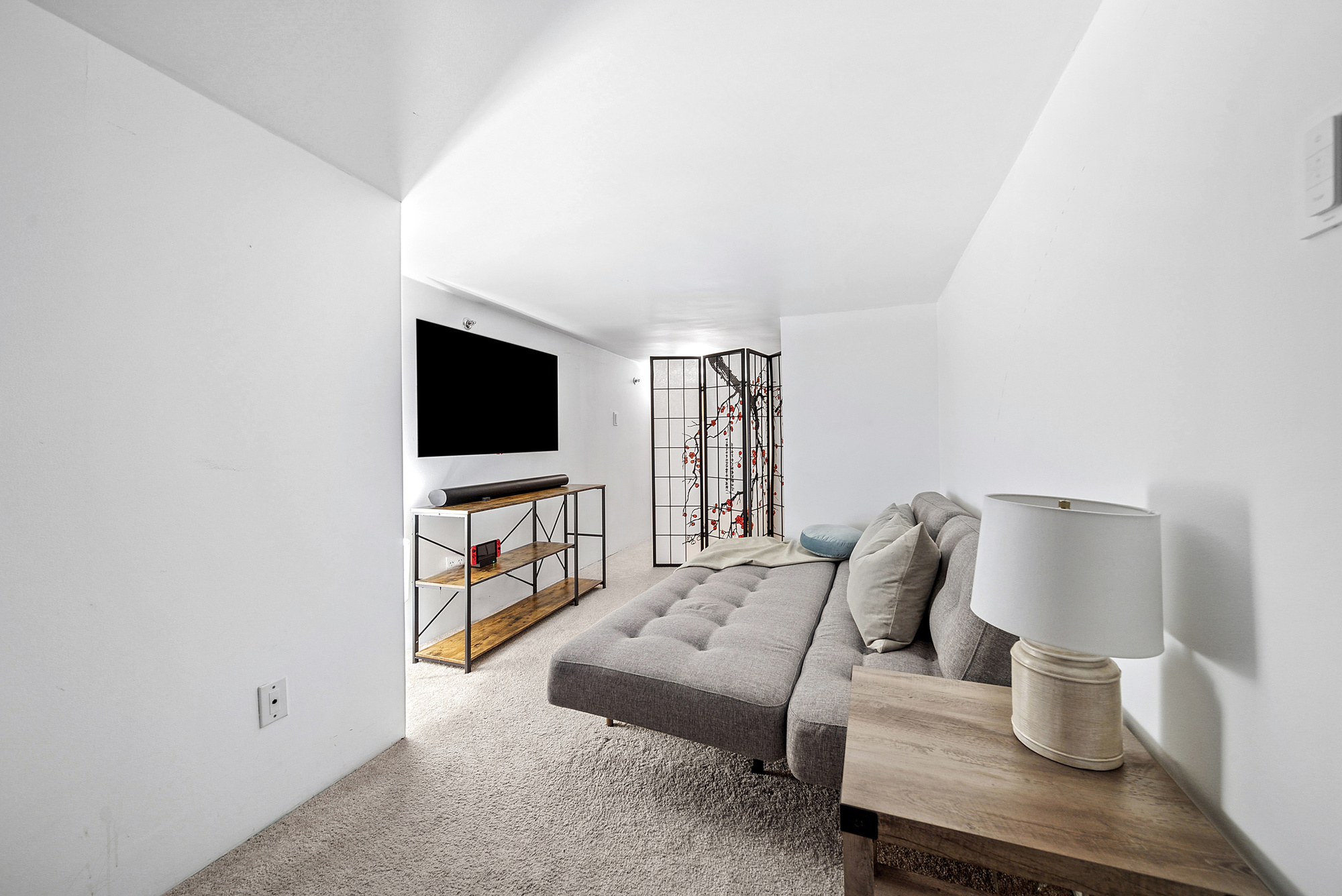 121 West 20th Street, Unit 3C Manhattan, NY 10011 - Photo 8 of 10 a living room with furniture and a flat screen tv