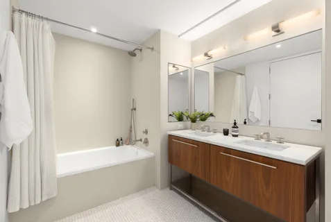 a bathroom with a double vanity sink mirror double and shower