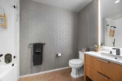 a bathroom with a toilet a sink and mirror