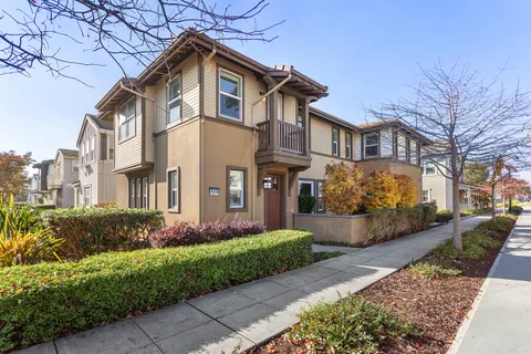 a front view of a house with a road and a garage