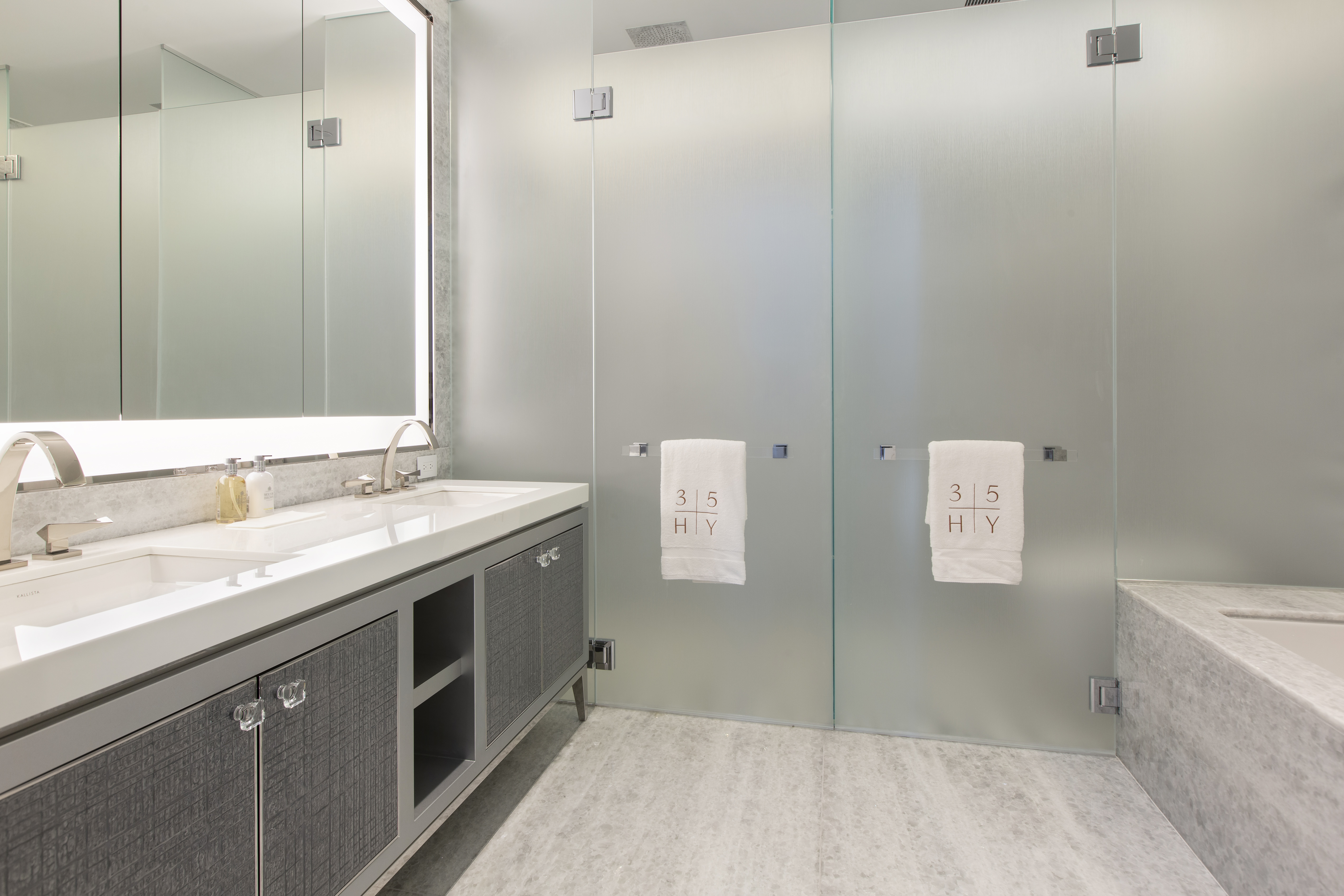 35 Hudson Yards, Unit 5805 Manhattan, NY 10001 - Photo 7 of 19 a bathroom with a granite countertop sink a toilet and shower