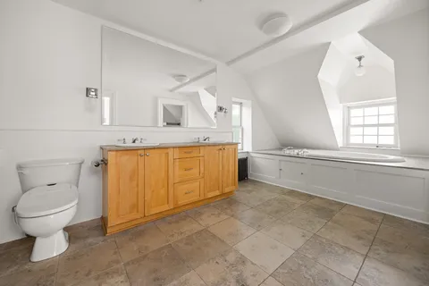 a bathroom with a toilet sink and mirror