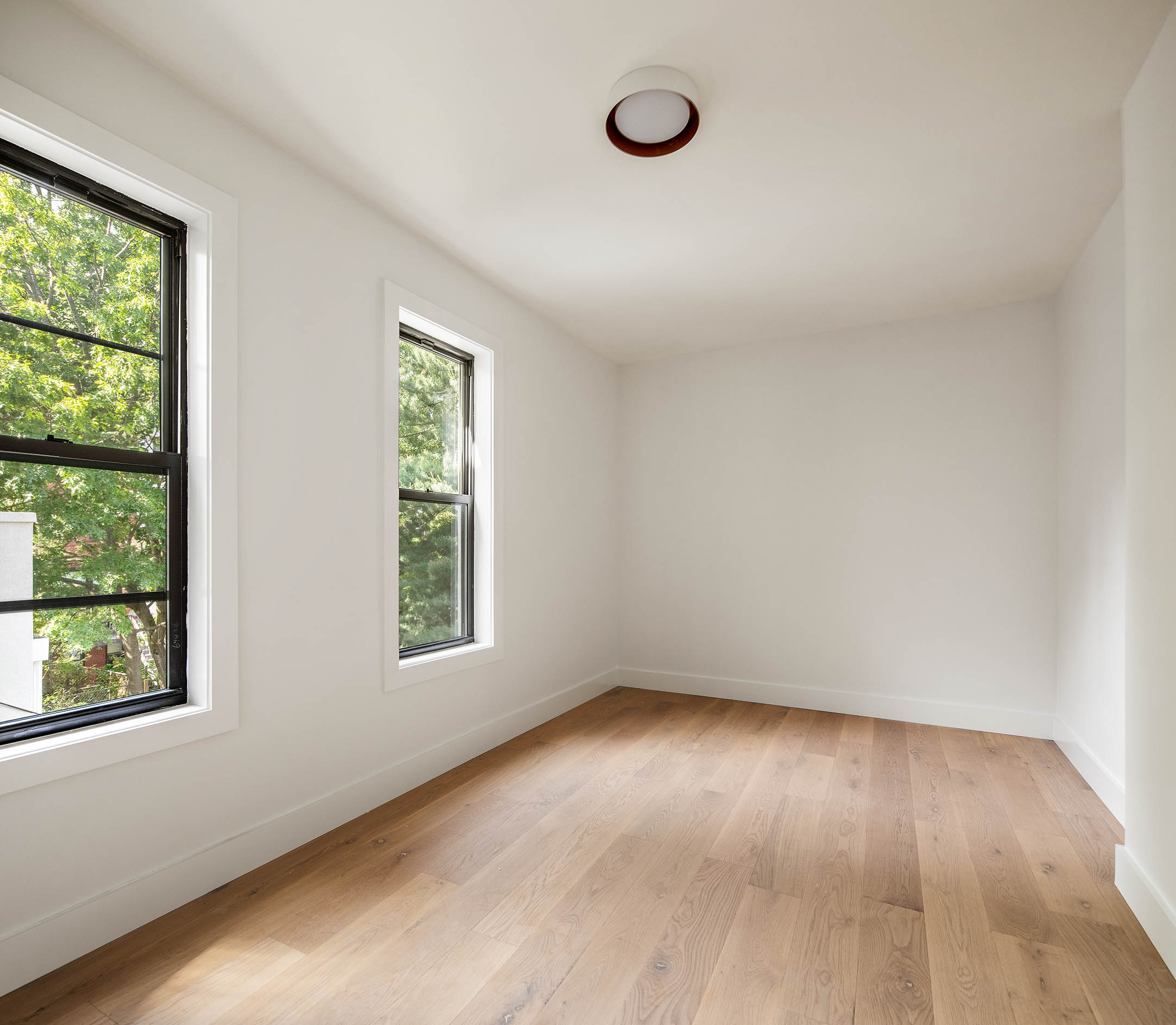 324 Clermont Avenue, Unit 4 Brooklyn, NY 11205 - Photo 6 of 9 an empty room with wooden floor and windows