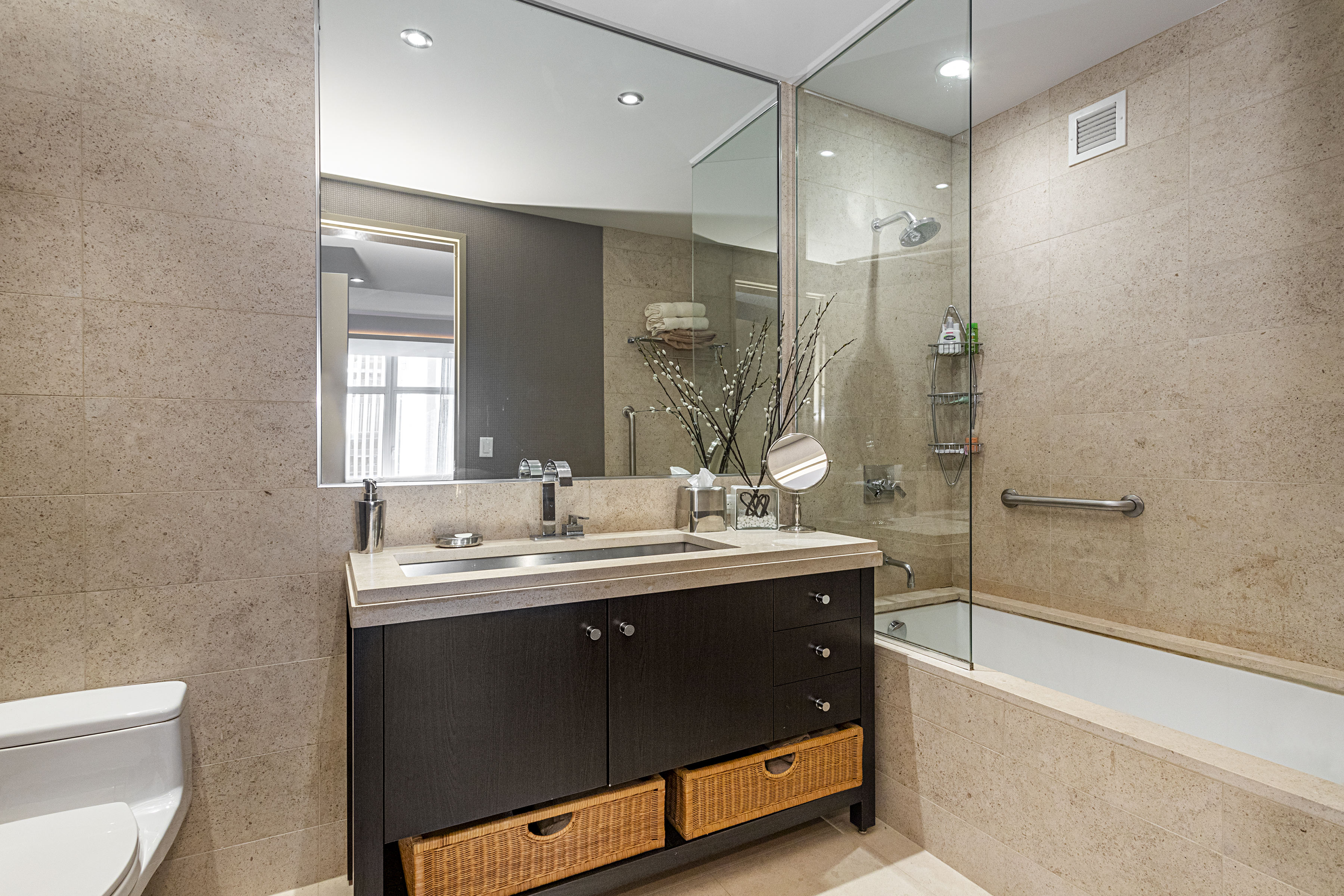 1600 Broadway, Unit 18G Manhattan, NY 10019 - Photo 7 of 10 a bathroom with a double vanity sink toilet mirror and bathtub