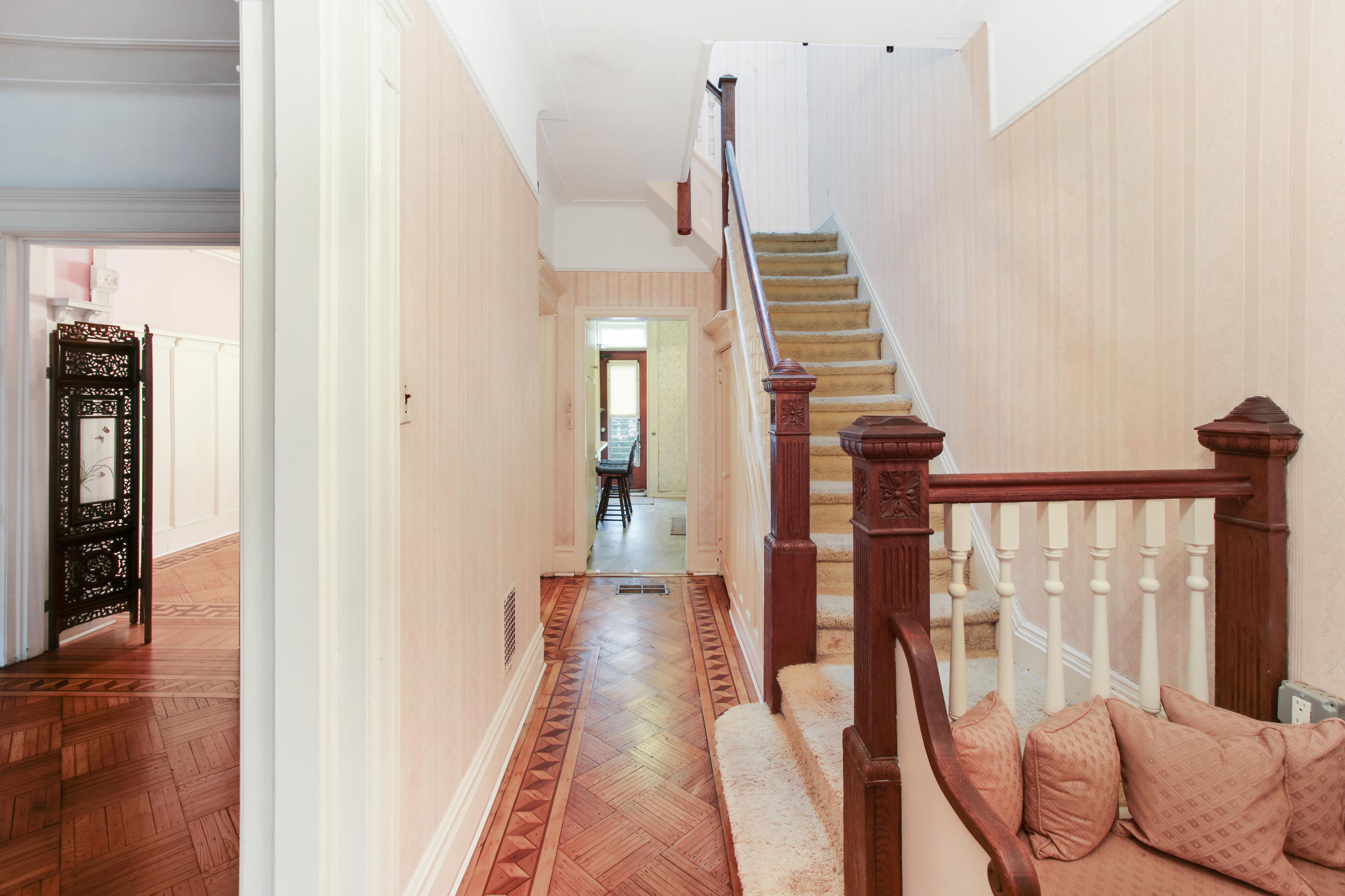 425 81st Street Brooklyn, NY 11209 - Photo 2 of 13 a view of a hallway with wooden floor and staircase