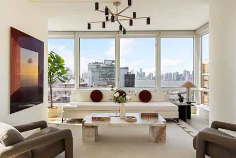 a living room with furniture and a floor to ceiling window
