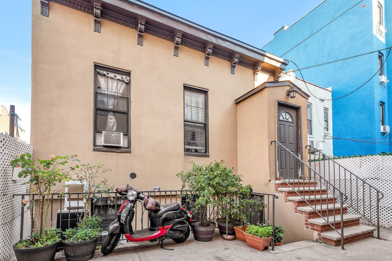 34-57 9th Street Queens, NY 11106 - Photo 2 of 10 a view of a house with many windows and plants