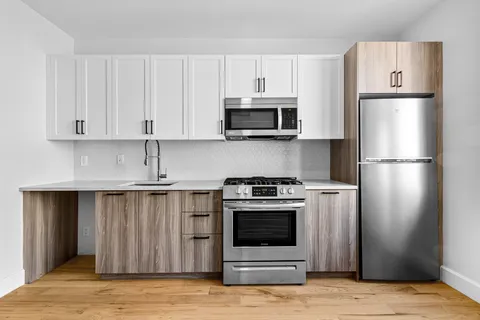 a kitchen with stainless steel appliances granite countertop a refrigerator stove and a sink