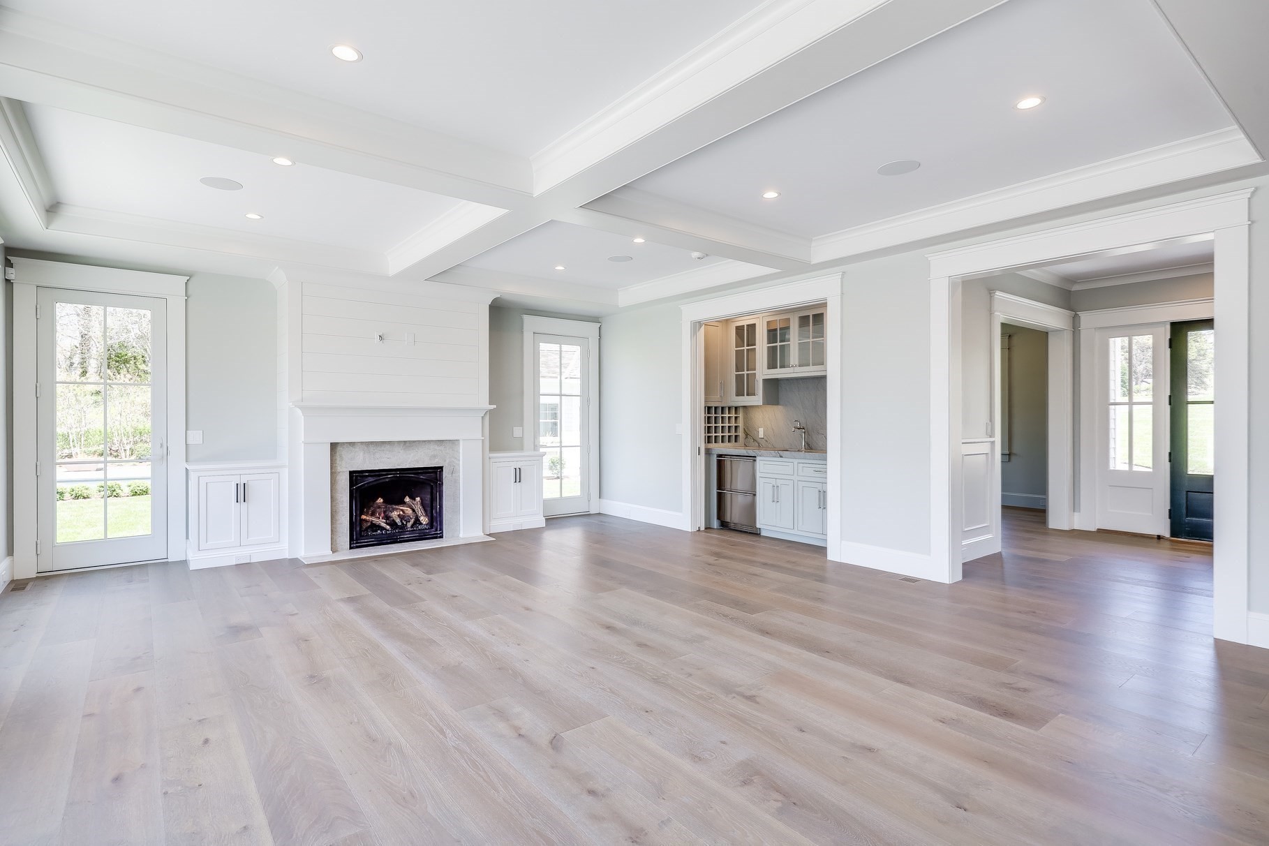 181 Dedham Street Dover, MA 02030 - Photo 3 of 19 an empty room with wooden floor fireplace and windows