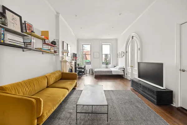 a living room with furniture and a fireplace