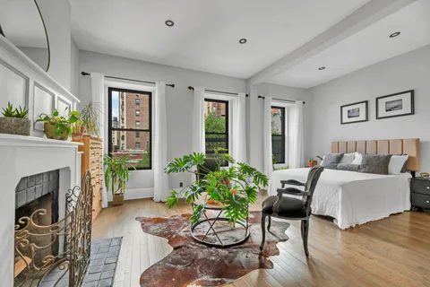 a living room with furniture fireplace and a large window