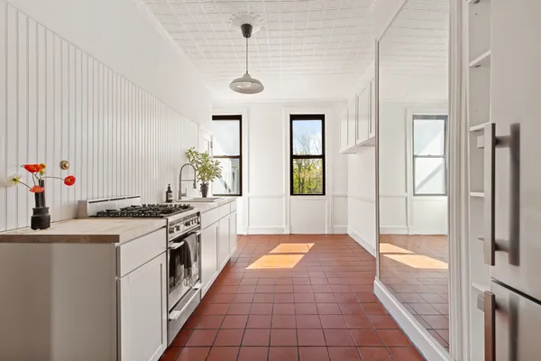 a large kitchen with stainless steel appliances granite countertop a stove a sink and a refrigerator