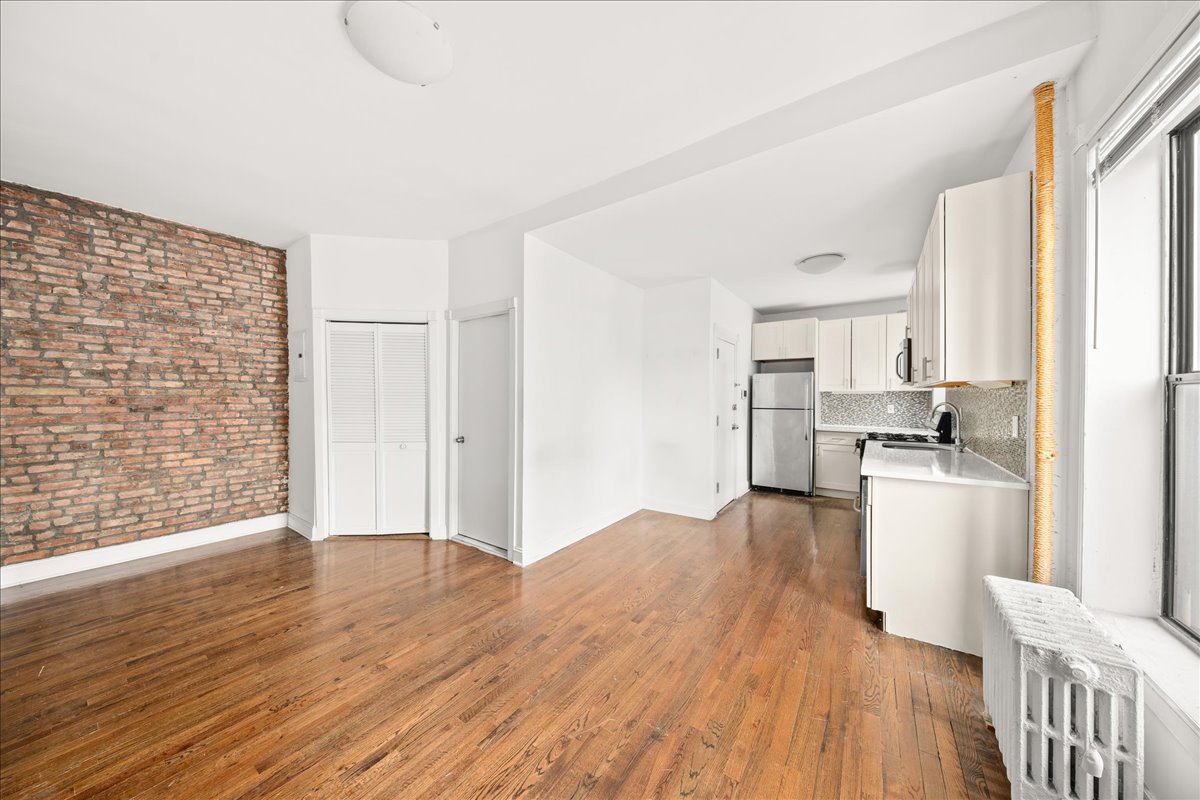 478 Halsey Street, Unit 1 Brooklyn, NY 11233 - Photo 2 of 10 a view of open kitchen with wooden floor and electronic appliances