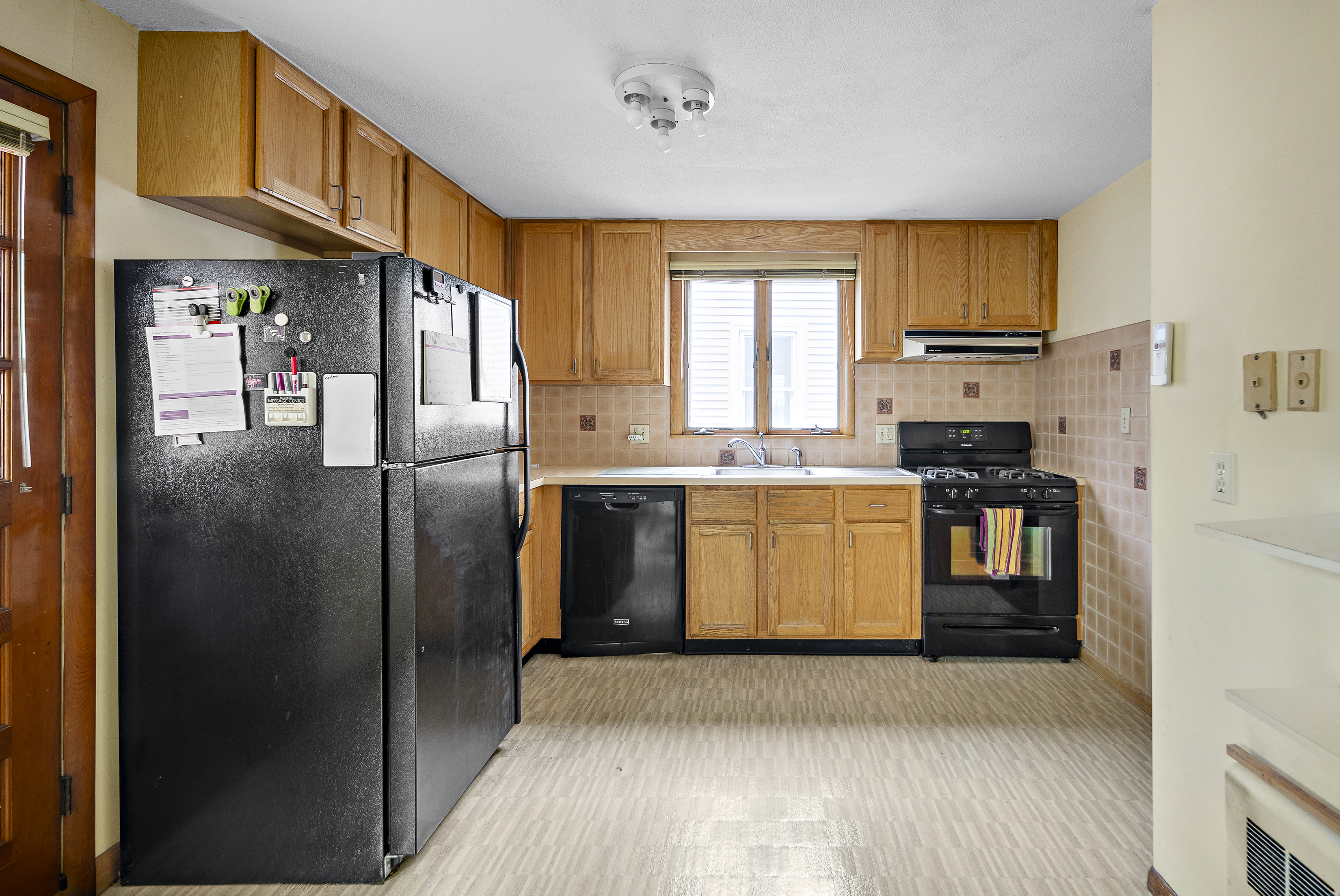 15 Harrington Road Cambridge, MA 02140 - Photo 5 of 17 a kitchen with stainless steel appliances granite countertop a refrigerator a stove and a sink with wooden floor