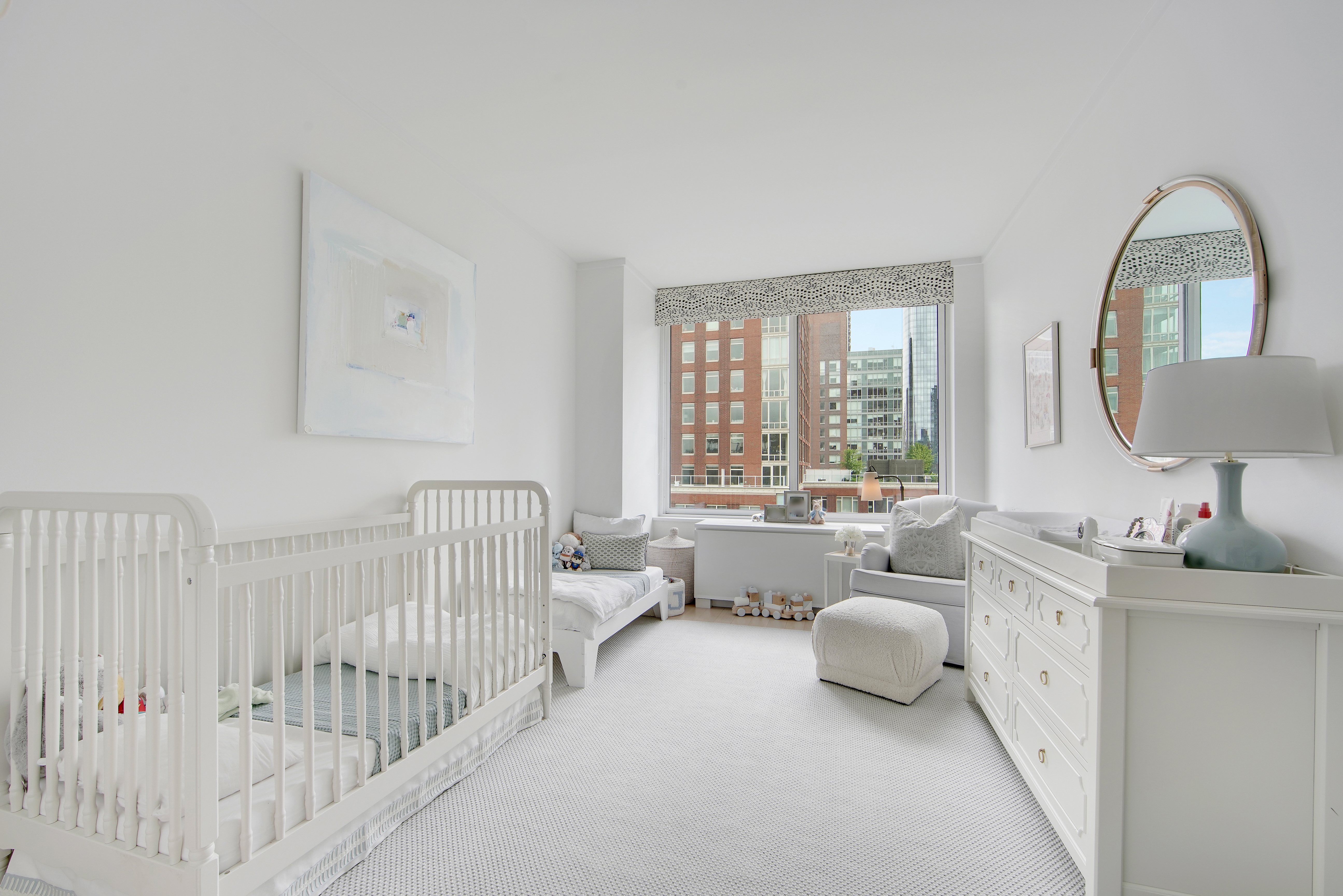 212 Warren Street, Unit 17S Manhattan, NY 10282 - Photo 10 of 15 a living room with furniture and a large window