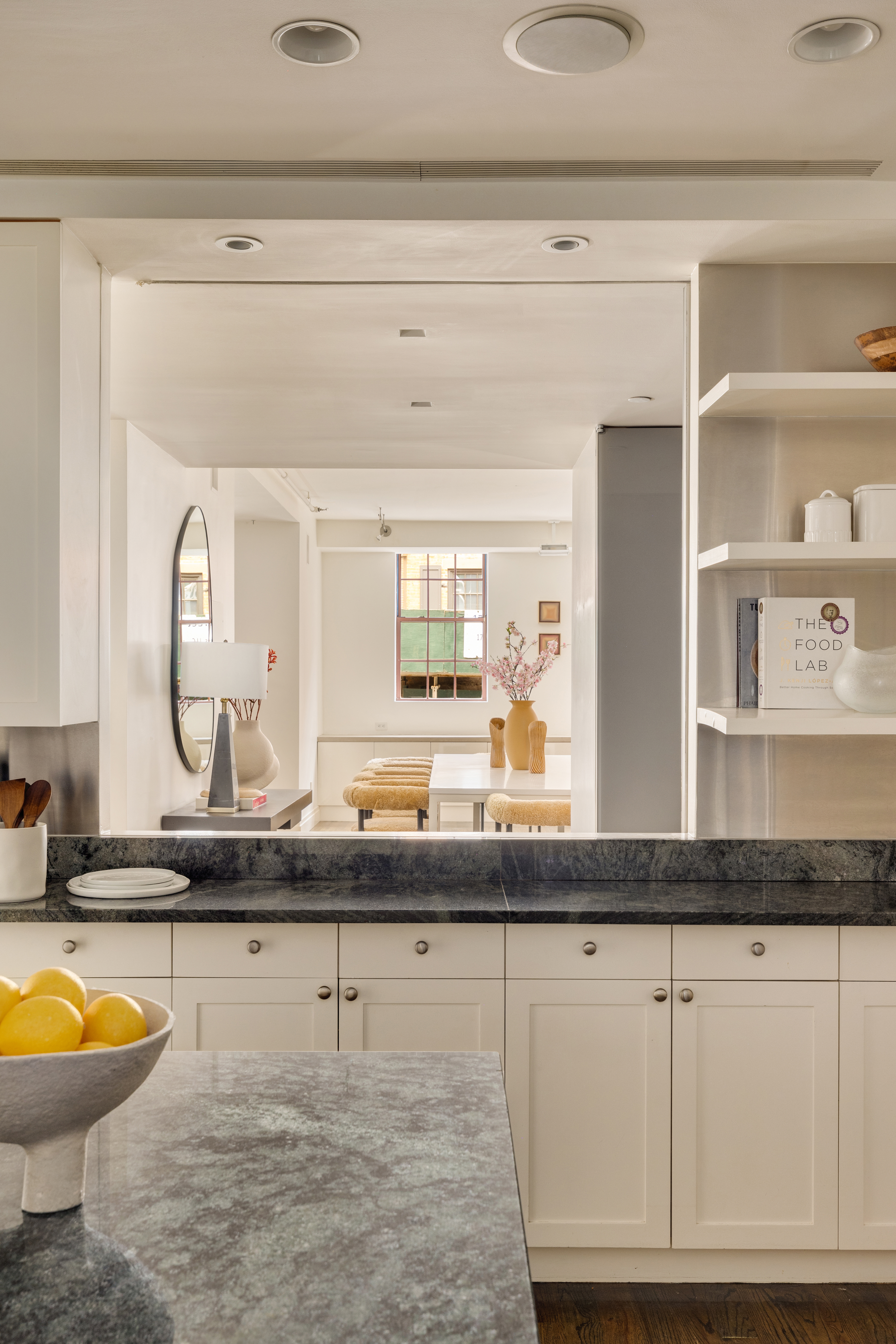 18 Leonard Street, Unit 2D Manhattan, NY 10013 - Photo 12 of 22 a bathroom with a granite countertop sink a mirror and a bathtub