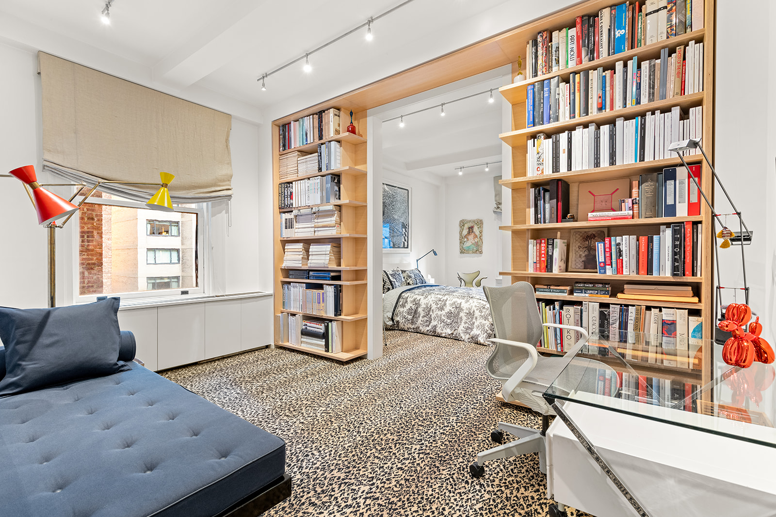 40 East 62nd Street, Unit 6E Manhattan, NY 10065 - Photo 18 of 25 a living room with furniture and a book shelf