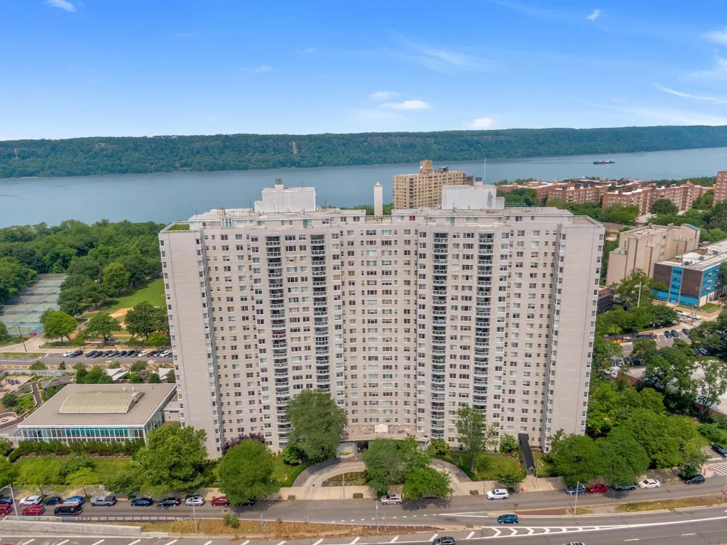 an aerial view of building with trees around