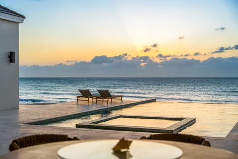 a view of a swimming pool with outdoor seating