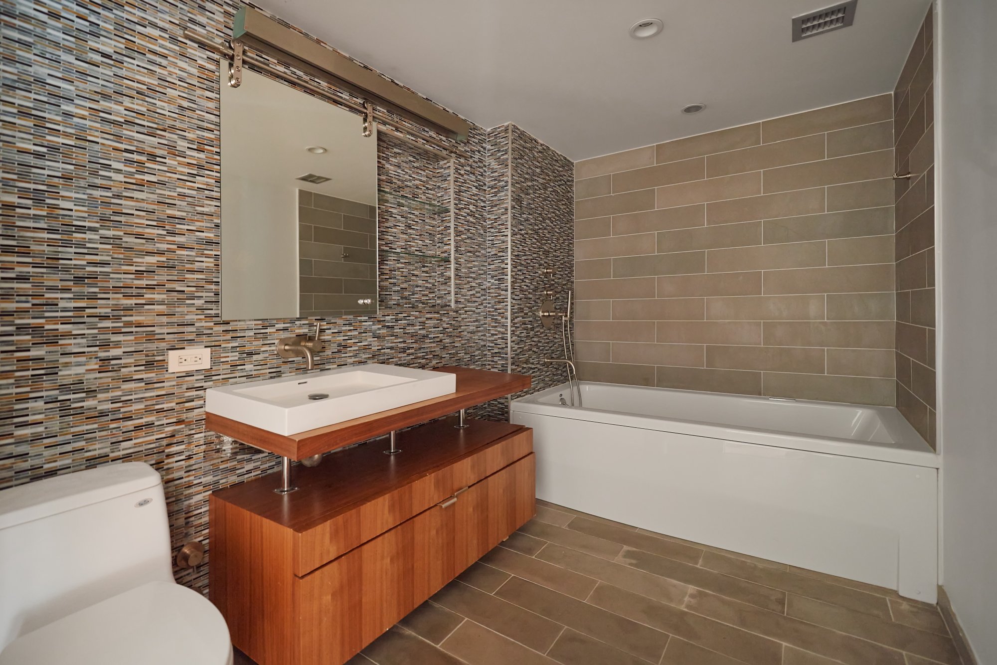 2280 Frederick Douglass Boulevard, Unit 5D Manhattan, NY 10027 - Photo 14 of 22 a bathroom with a sink toilet and shower