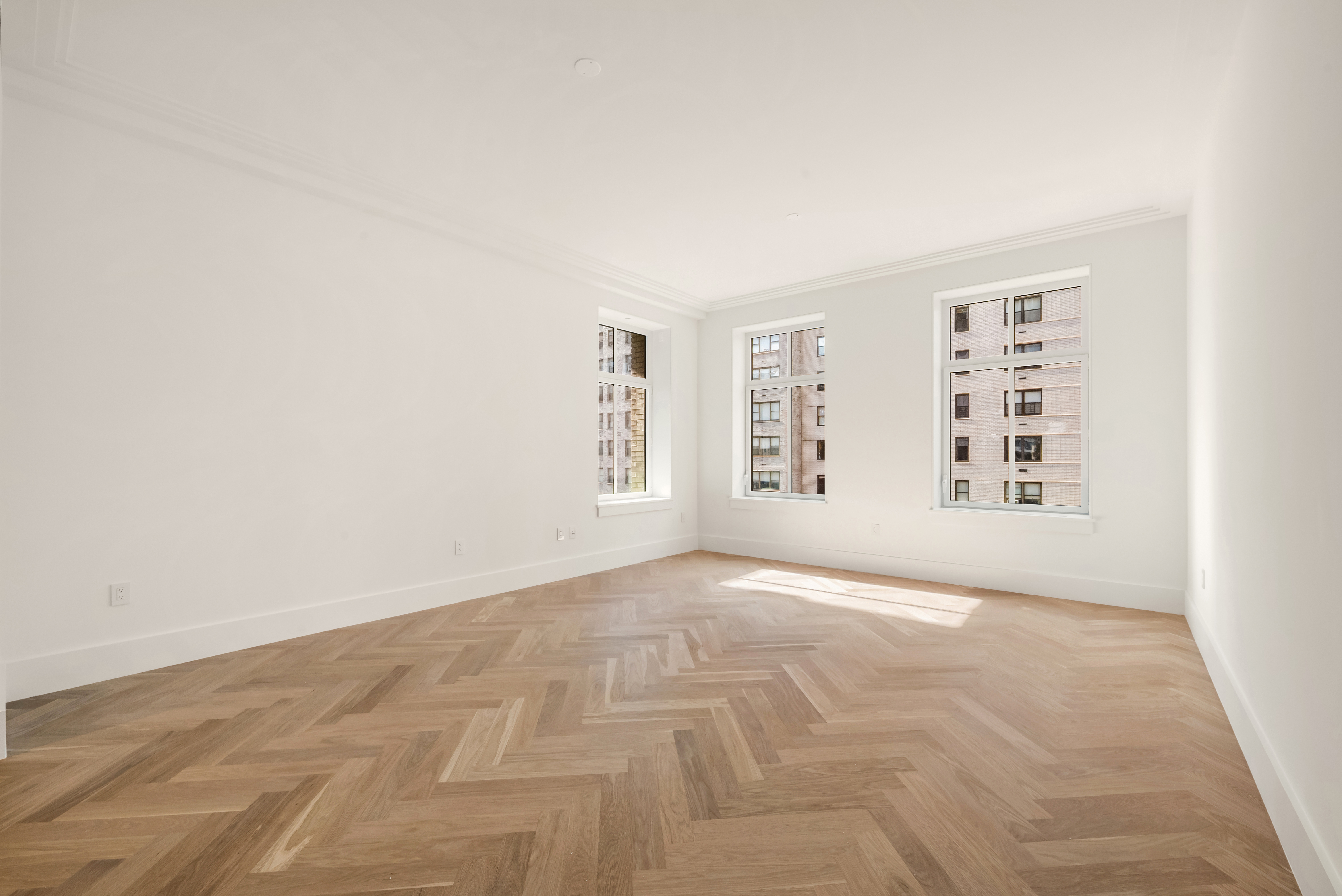 200 East 75th Street, Unit 6C Manhattan, NY 10021 - Photo 2 of 11 an empty room with windows