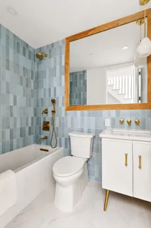 a bathroom with a sink a toilet and bathtub