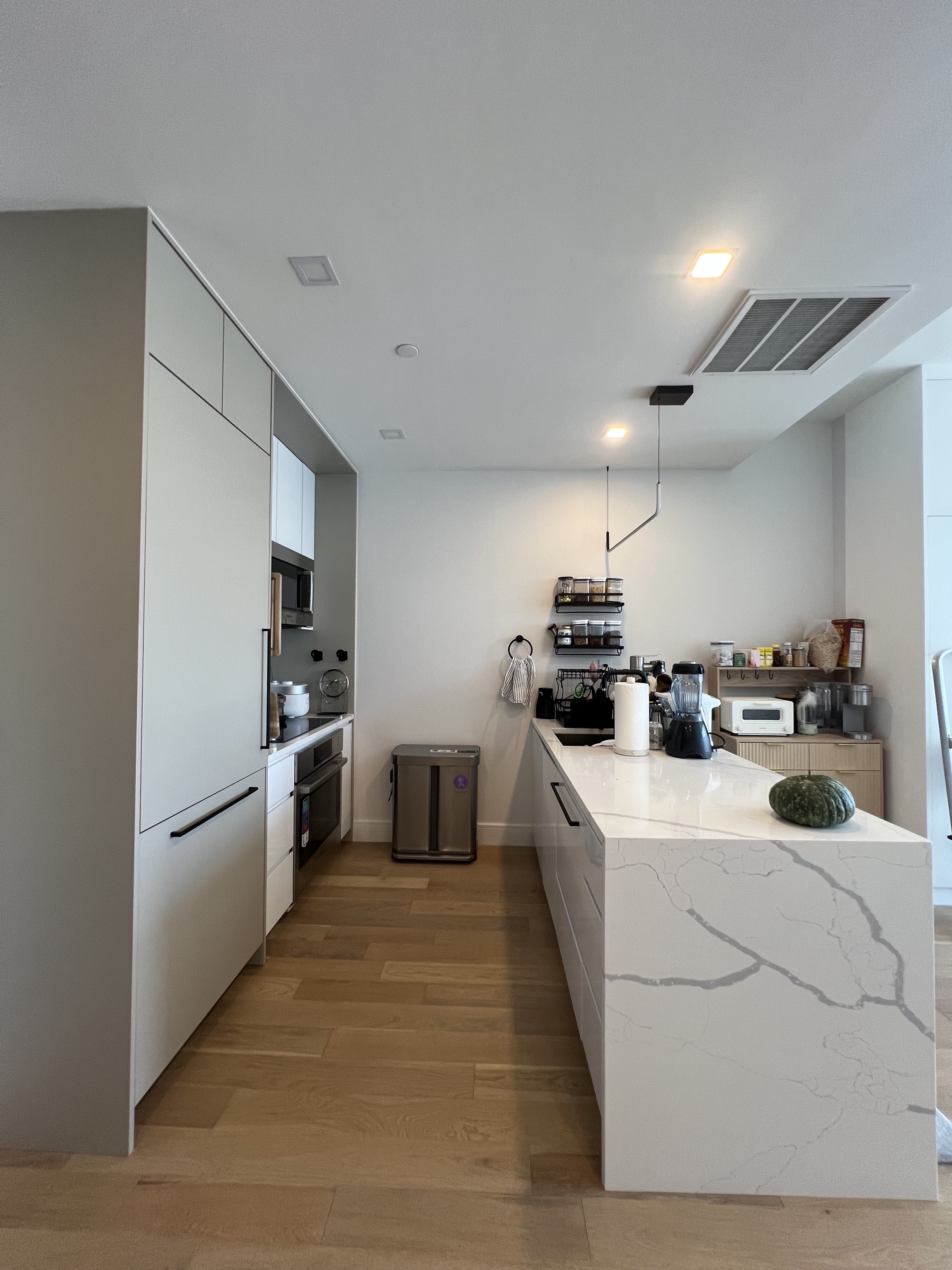 37-34 33rd Street, Unit 7H Queens, NY 11101 - Photo 3 of 18 a kitchen with white cabinets and white appliances